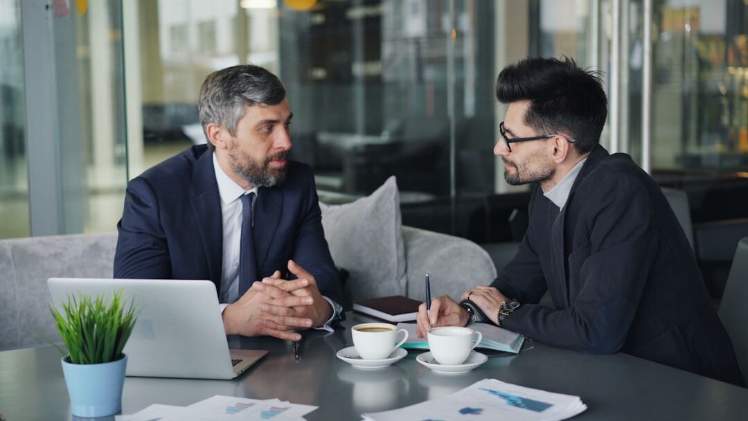 Finance professionals reviewing charts and reports in a meeting
